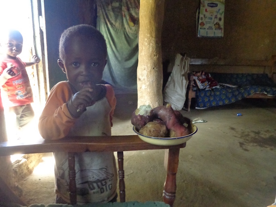 A Child eating a plate of Sweet Potatoes